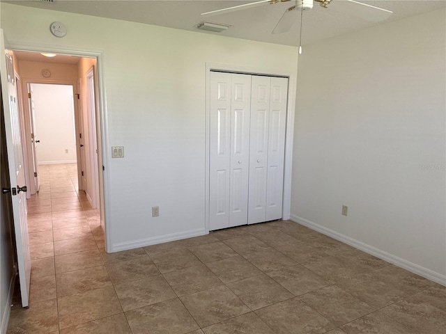 17483 SE 74th Netherclift Ter, The Villages, FL 32162 - unfurnished bedroom featuring tile patterned floors, a closet, and a ceiling fan