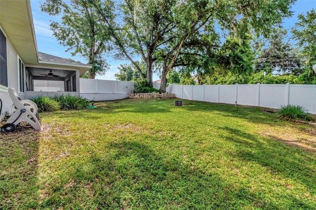 1511 W Magnolia St, Clermont, FL 34711 - fenced backyard featuring a ceiling fan and a sunroom