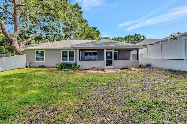 1511 W Magnolia St, Clermont, FL 34711 - back of house featuring a sunroom, roof with shingles, a fenced backyard, and stucco siding