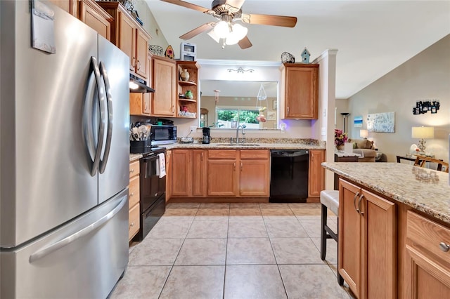 1511 W Magnolia St, Clermont, FL 34711 - kitchen featuring black appliances, under cabinet range hood, ceiling fan, light stone countertops, and light tile patterned floors