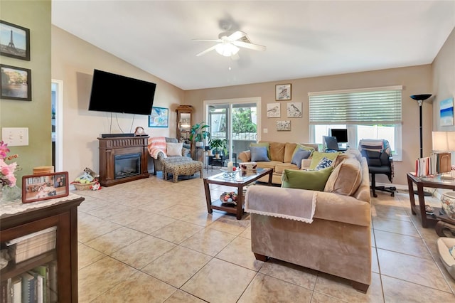 1511 W Magnolia St, Clermont, FL 34711 - living room featuring a ceiling fan, light tile patterned flooring, a glass covered fireplace, and lofted ceiling