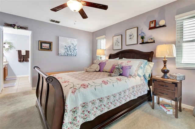 1511 W Magnolia St, Clermont, FL 34711 - bedroom featuring light carpet, ceiling fan, and ensuite bathroom