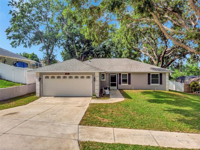 1511 W Magnolia St, Clermont, FL 34711 - ranch-style home with a garage, stucco siding, driveway, and roof with shingles