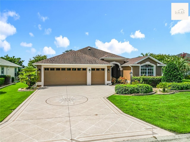 2994 Adrienne Way, The Villages, FL 32163 - view of front facade with stucco siding, an attached garage, a front lawn, and driveway