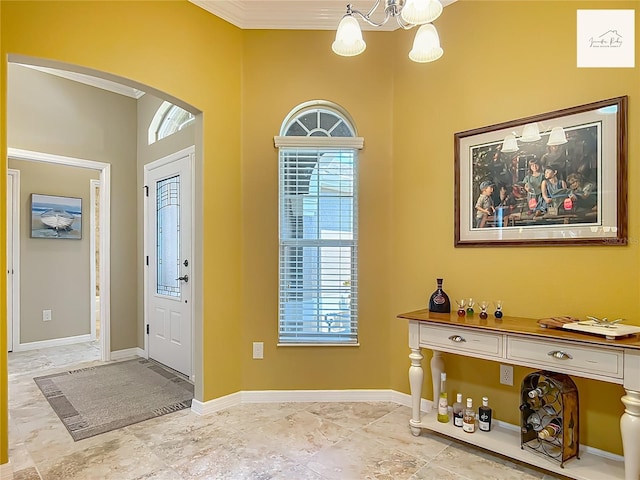 2994 Adrienne Way, The Villages, FL 32163 - foyer with arched walkways, a chandelier, and crown molding