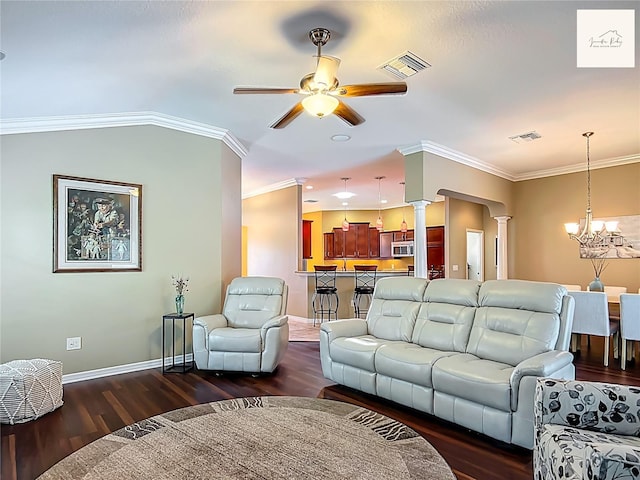 2994 Adrienne Way, The Villages, FL 32163 - living room featuring decorative columns, dark wood-style floors, ceiling fan, a chandelier, and crown molding