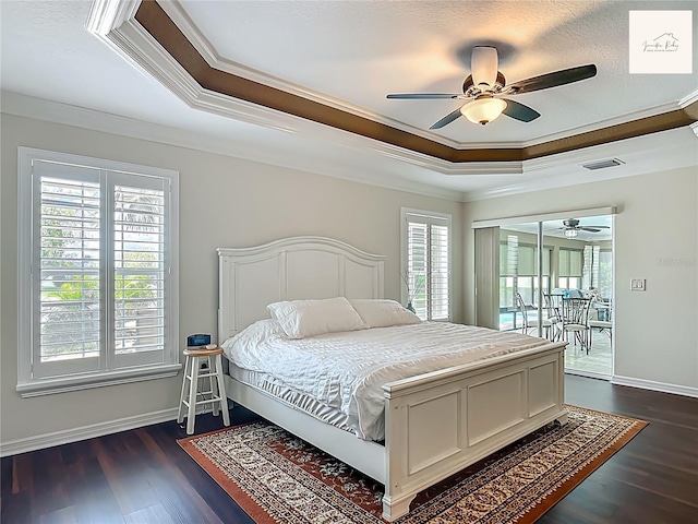 2994 Adrienne Way, The Villages, FL 32163 - bedroom featuring a tray ceiling, crown molding, access to exterior, dark wood finished floors, and a ceiling fan