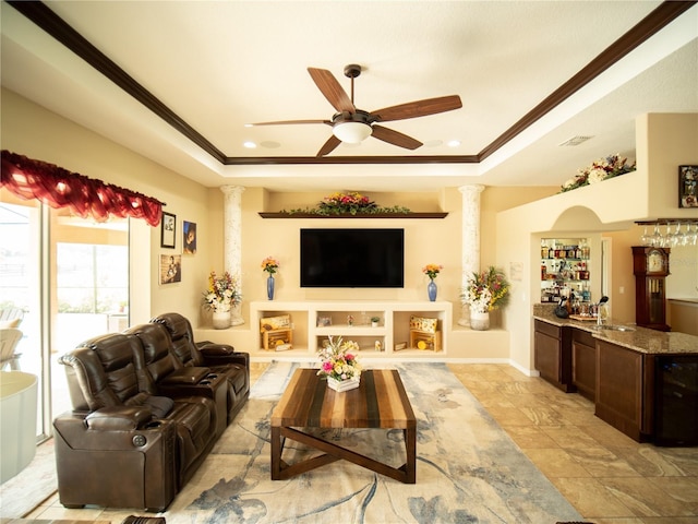 29222 Can Do Ln, Tavares, FL 32778 - living room with ornate columns, a tray ceiling, ceiling fan, beverage cooler, and crown molding