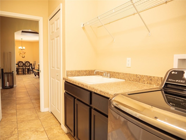 29222 Can Do Ln, Tavares, FL 32778 - laundry area featuring arched walkways, light tile patterned flooring, cabinet space, hookup for a washing machine, and a chandelier