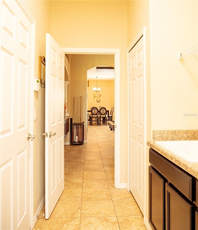 29222 Can Do Ln, Tavares, FL 32778 - hallway featuring arched walkways, light tile patterned floors, and a chandelier