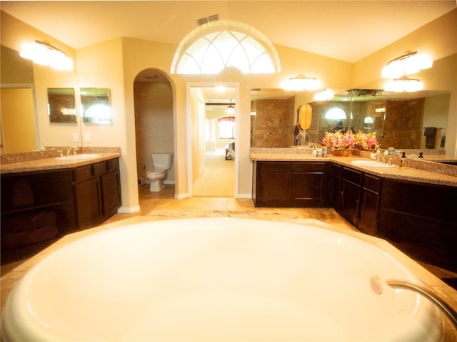 29222 Can Do Ln, Tavares, FL 32778 - full bath featuring two vanities, vaulted ceiling, and a garden tub