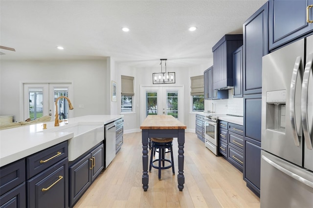 15629 Catherine Cir, Groveland, FL 34736 - kitchen with appliances with stainless steel finishes, recessed lighting, french doors, light wood-type flooring, and tasteful backsplash