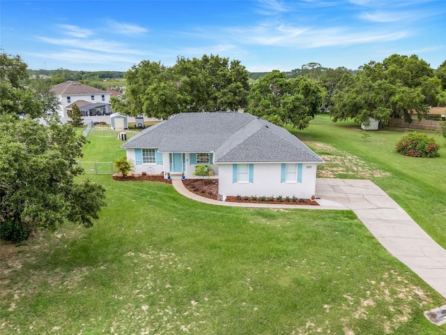 15629 Catherine Cir, Groveland, FL 34736 - single story home with a shingled roof, stucco siding, view of scattered trees, and driveway