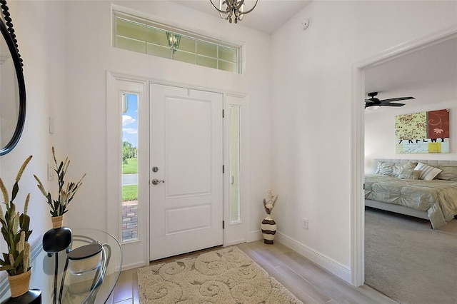 10363 Addison Shore Way, Oxford, FL 34484 - foyer featuring baseboards and a chandelier