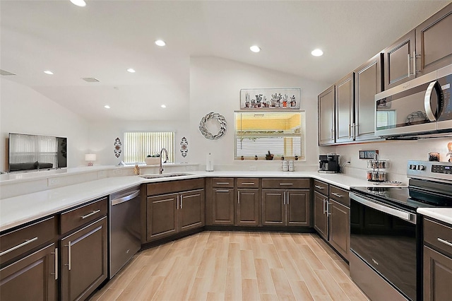 10363 Addison Shore Way, Oxford, FL 34484 - kitchen featuring appliances with stainless steel finishes, vaulted ceiling, light countertops, dark brown cabinets, and recessed lighting