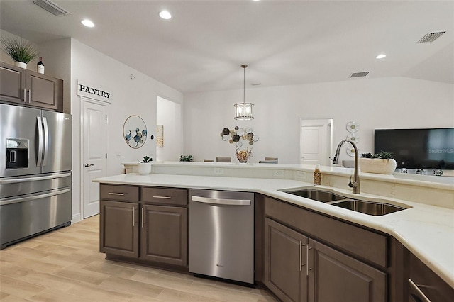 10363 Addison Shore Way, Oxford, FL 34484 - kitchen featuring appliances with stainless steel finishes, light countertops, light wood-style flooring, recessed lighting, and hanging light fixtures