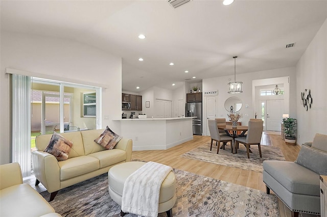 10363 Addison Shore Way, Oxford, FL 34484 - living room featuring light wood finished floors, recessed lighting, and lofted ceiling