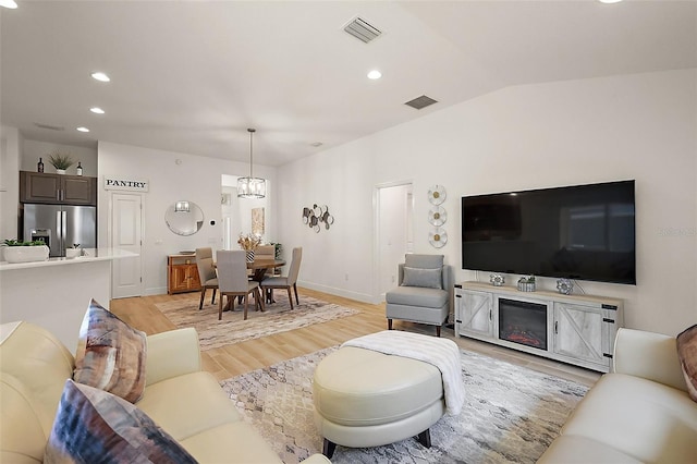 10363 Addison Shore Way, Oxford, FL 34484 - living room featuring recessed lighting, light wood finished floors, a chandelier, and lofted ceiling