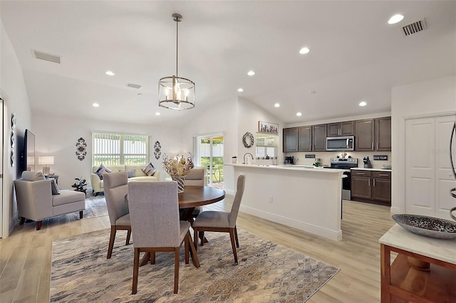 10363 Addison Shore Way, Oxford, FL 34484 - dining area featuring recessed lighting, light wood-style floors, lofted ceiling, and a chandelier