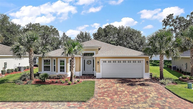 10363 Addison Shore Way, Oxford, FL 34484 - ranch-style house with stucco siding, decorative driveway, an attached garage, and a front lawn