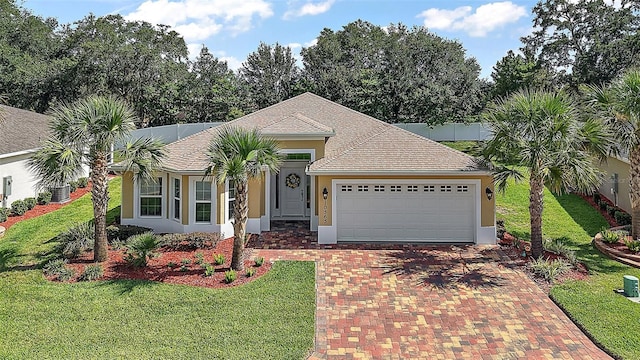 10363 Addison Shore Way, Oxford, FL 34484 - single story home featuring decorative driveway, a garage, stucco siding, and a front lawn