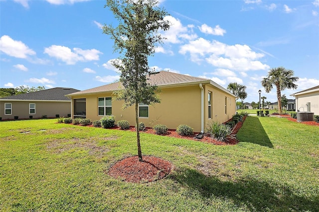 10363 Addison Shore Way, Oxford, FL 34484 - rear view of house with a lawn and stucco siding
