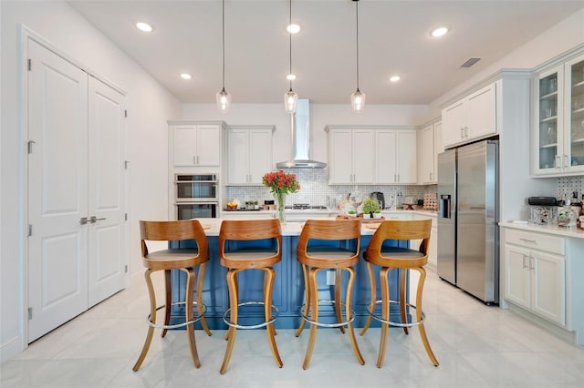 1990 Wallingford Loop, Mount Dora, FL 32757 - kitchen with appliances with stainless steel finishes, wall chimney exhaust hood, decorative backsplash, light countertops, and recessed lighting
