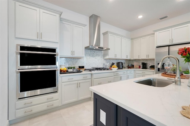 1990 Wallingford Loop, Mount Dora, FL 32757 - kitchen with wall chimney range hood, stainless steel appliances, white cabinets, and recessed lighting