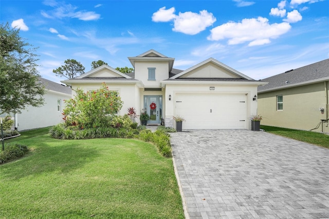 1990 Wallingford Loop, Mount Dora, FL 32757 - ranch-style home with decorative driveway, a front yard, stucco siding, and an attached garage
