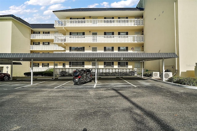 101 N Grandview St Unit 103, Mount Dora, FL 32757 - view of apartment building / complex featuring covered parking