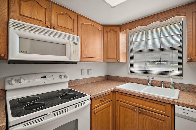 101 N Grandview St Unit 103, Mount Dora, FL 32757 - kitchen with white appliances and brown cabinetry