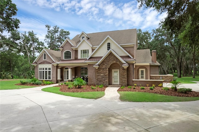 1325 Otters View Ct, Fruitland Park, FL 34731 - view of front of house featuring a front yard, stone siding, a chimney, and a shingled roof