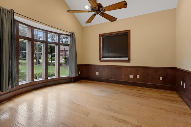 1325 Otters View Ct, Fruitland Park, FL 34731 - empty room featuring light wood finished floors, a wainscoted wall, lofted ceiling, a ceiling fan, and wood walls