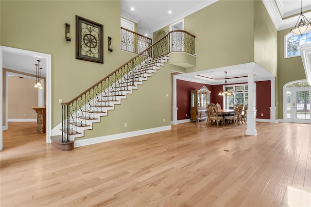 1325 Otters View Ct, Fruitland Park, FL 34731 - foyer with ornamental molding, a towering ceiling, plenty of natural light, wood finished floors, and a chandelier
