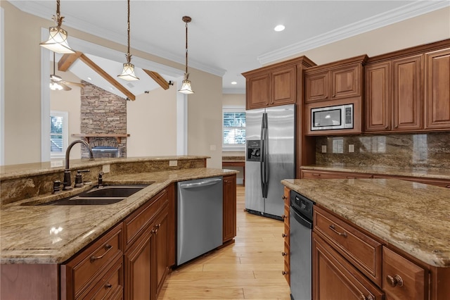 1325 Otters View Ct, Fruitland Park, FL 34731 - kitchen featuring stainless steel appliances, light wood-style flooring, a ceiling fan, decorative light fixtures, and brown cabinetry
