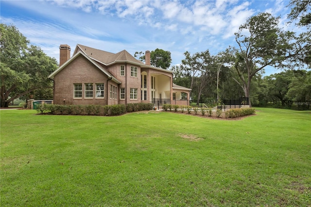 1325 Otters View Ct, Fruitland Park, FL 34731 - back of house featuring a chimney and brick siding