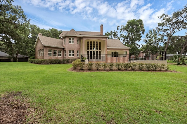 1325 Otters View Ct, Fruitland Park, FL 34731 - back of property with french doors, a chimney, and stucco siding