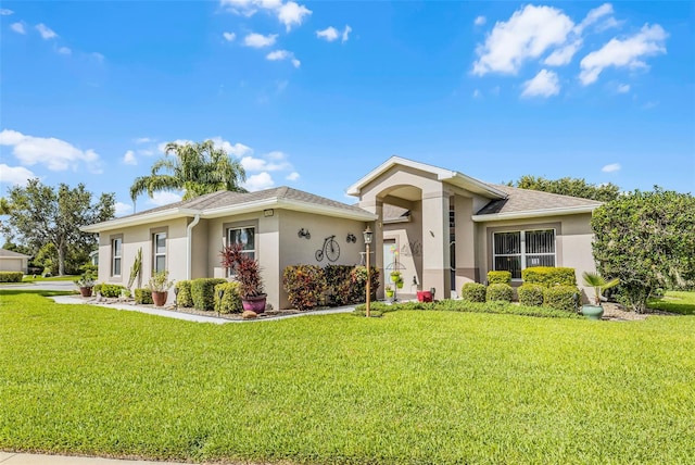 5620 Illumination Ln, Leesburg, FL 34748 - view of front of home with stucco siding, a front yard, and a shingled roof