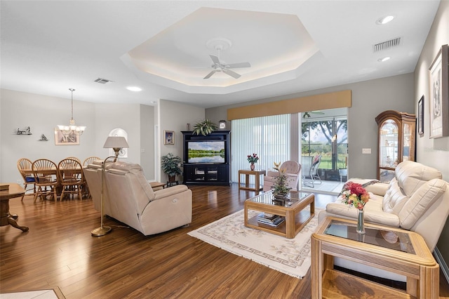 5620 Illumination Ln, Leesburg, FL 34748 - living room featuring dark wood-style floors, a ceiling fan, a raised ceiling, recessed lighting, and a chandelier