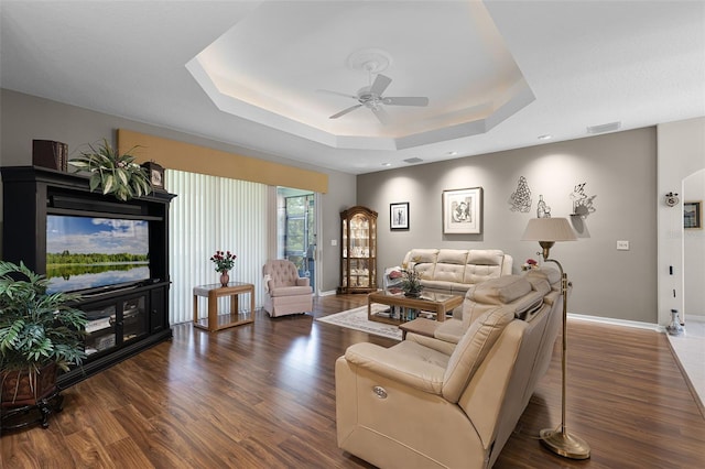 5620 Illumination Ln, Leesburg, FL 34748 - living area featuring a ceiling fan, a tray ceiling, and wood finished floors