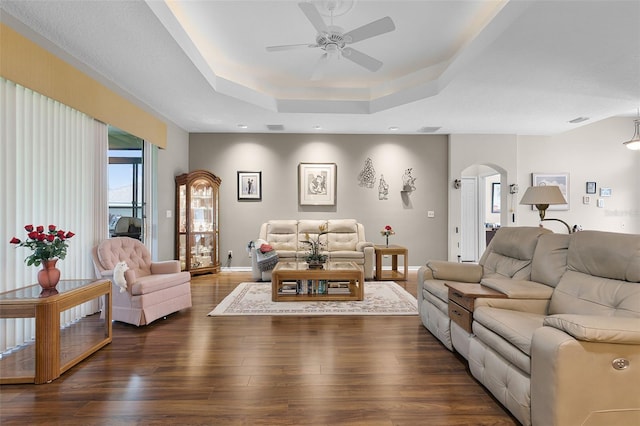 5620 Illumination Ln, Leesburg, FL 34748 - living area with arched walkways, a ceiling fan, a raised ceiling, and dark wood finished floors