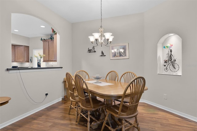 5620 Illumination Ln, Leesburg, FL 34748 - dining room with dark wood finished floors, a chandelier, arched walkways, and recessed lighting