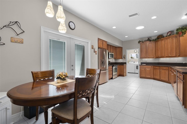 5620 Illumination Ln, Leesburg, FL 34748 - dining room featuring washing machine and dryer, light tile patterned flooring, recessed lighting, and french doors
