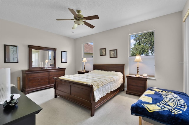 5620 Illumination Ln, Leesburg, FL 34748 - bedroom featuring light carpet, multiple windows, a ceiling fan, and a textured ceiling