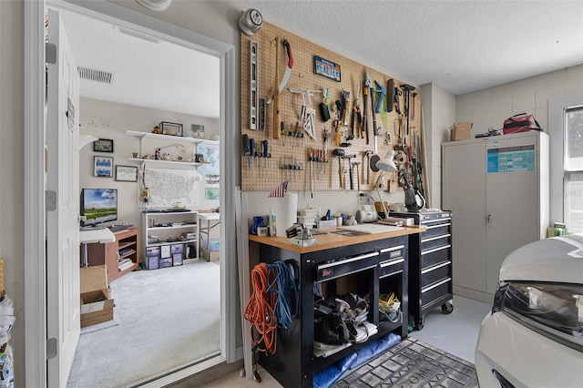 5620 Illumination Ln, Leesburg, FL 34748 - miscellaneous room featuring a workshop area and a textured ceiling