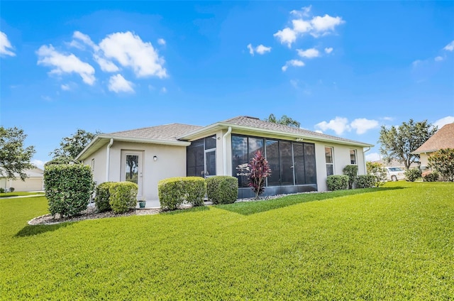 5620 Illumination Ln, Leesburg, FL 34748 - back of house with a lawn, a sunroom, and stucco siding