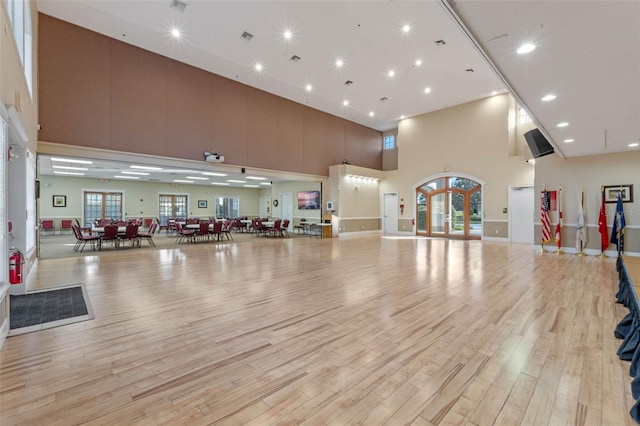 5620 Illumination Ln, Leesburg, FL 34748 - exercise room featuring a towering ceiling, light wood-style flooring, and recessed lighting