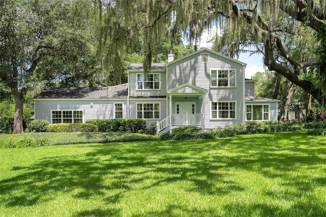 9223 Silver Lake Dr, Leesburg, FL 34788 - traditional-style home featuring a front lawn and a chimney