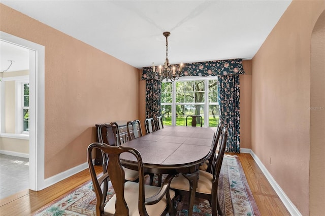 9223 Silver Lake Dr, Leesburg, FL 34788 - dining room with light wood-type flooring and a chandelier