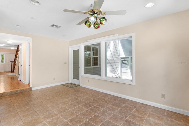 9223 Silver Lake Dr, Leesburg, FL 34788 - tiled spare room with ceiling fan, stairway, and recessed lighting